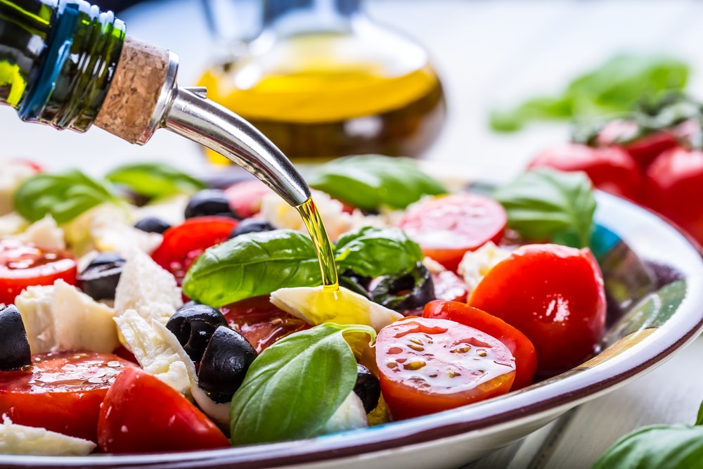 Oil being poured onto a salad