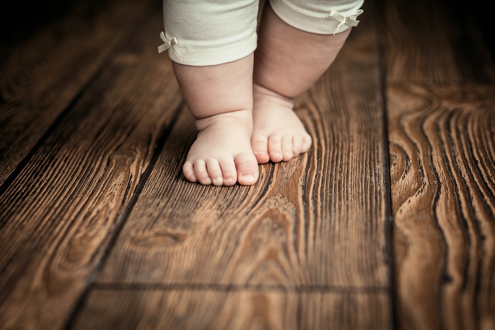 baby footsteps on a wooden floor