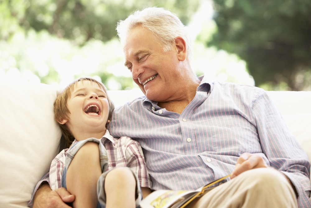 This is photo of a man and his grandson laughing together