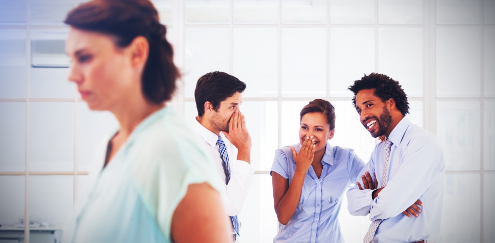 This is photo of people at work laughing at a colleague
