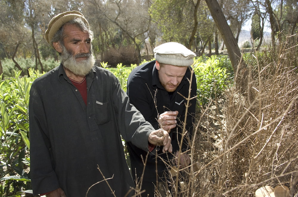 James Brett with a farmer for Plant for Peace
