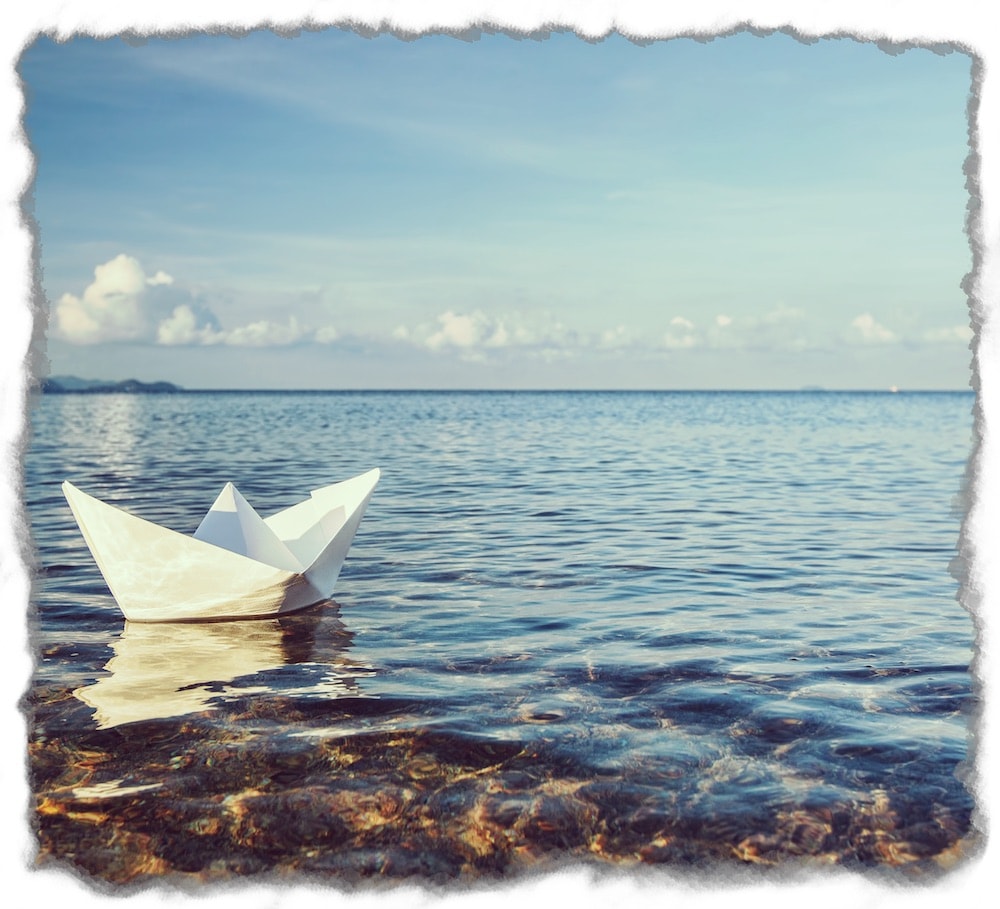 Paper Boat Floating on the Sea