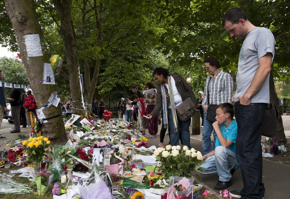 People laying flowers outside Amy Winehouse's house after she passed away in 2011