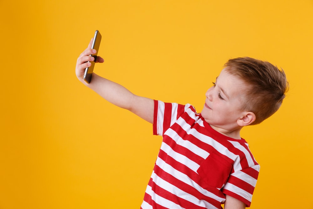 Young-boy-plays-with-mobile-phone-2