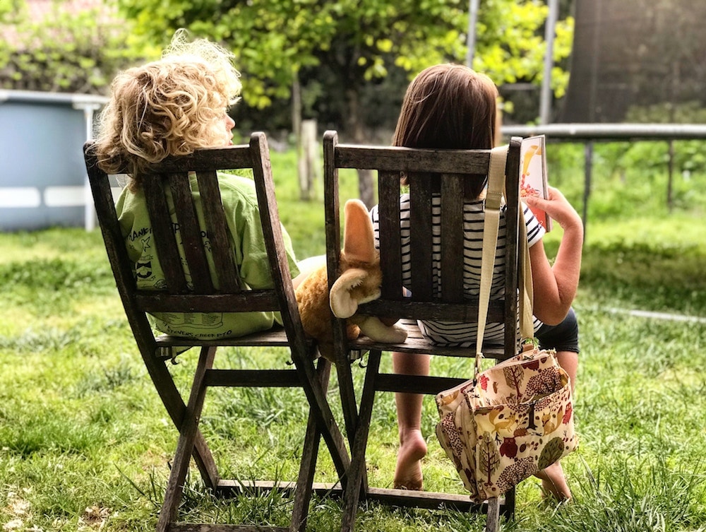 children sat together in garden
