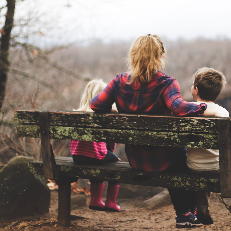 Parent-shares-advice-with-two-children-on-bench