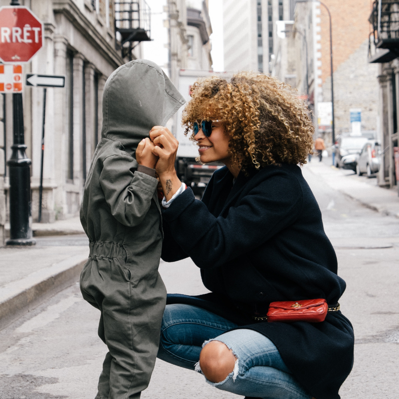 parent-talks-to-child-about-mistake-outside-while-smiling