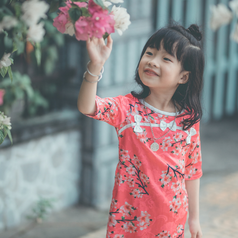 Young-girl-curiously-looks-at-flowers