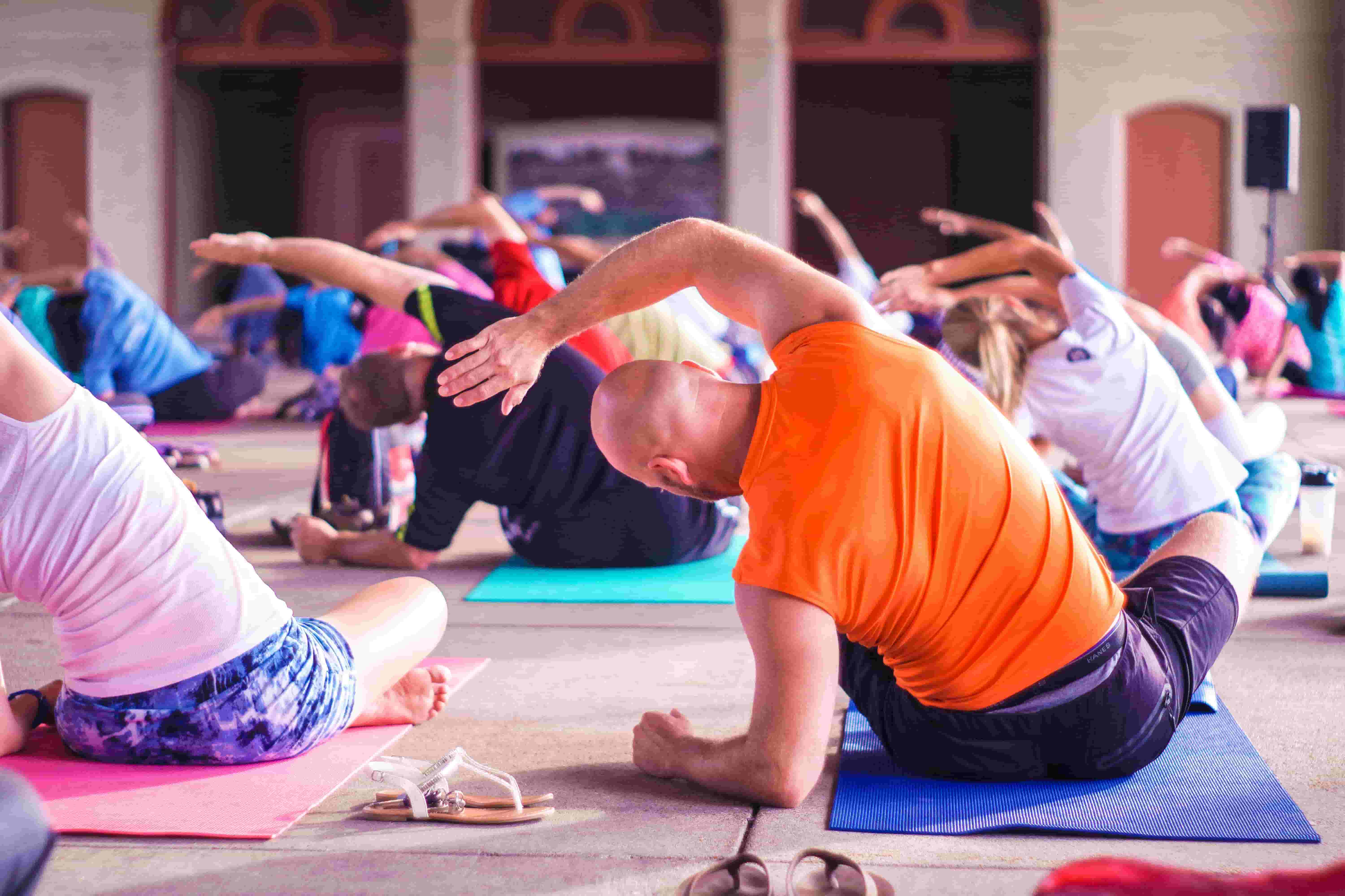 A middle-aged man takes part in a yoga class
