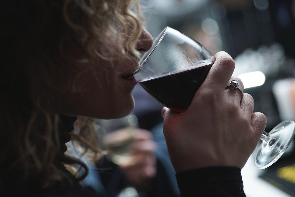 woman drinking red wine from a glass