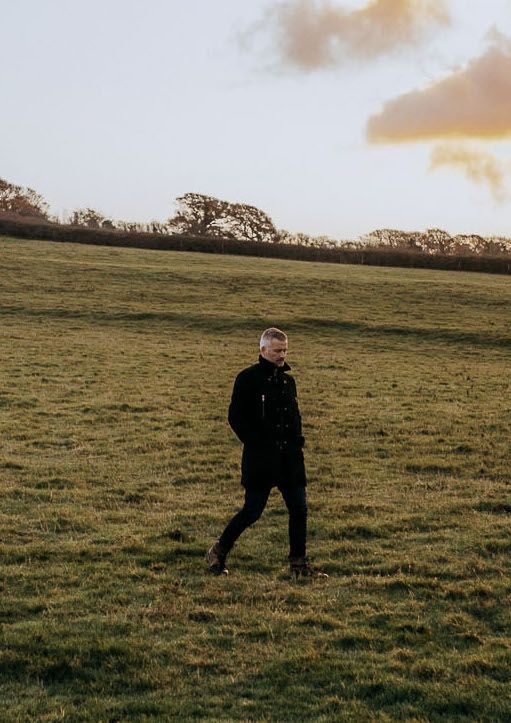 Jonathan walking in a field