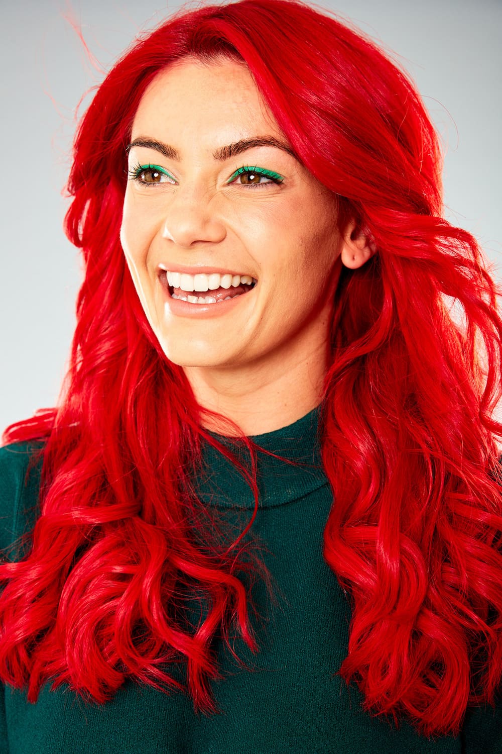 Dianne Buswell smiling, looking away from the camera