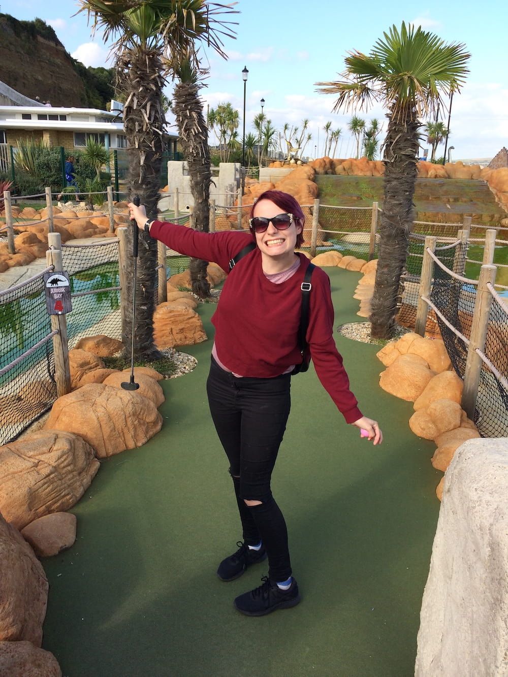 Stacey smiling playing mini golf