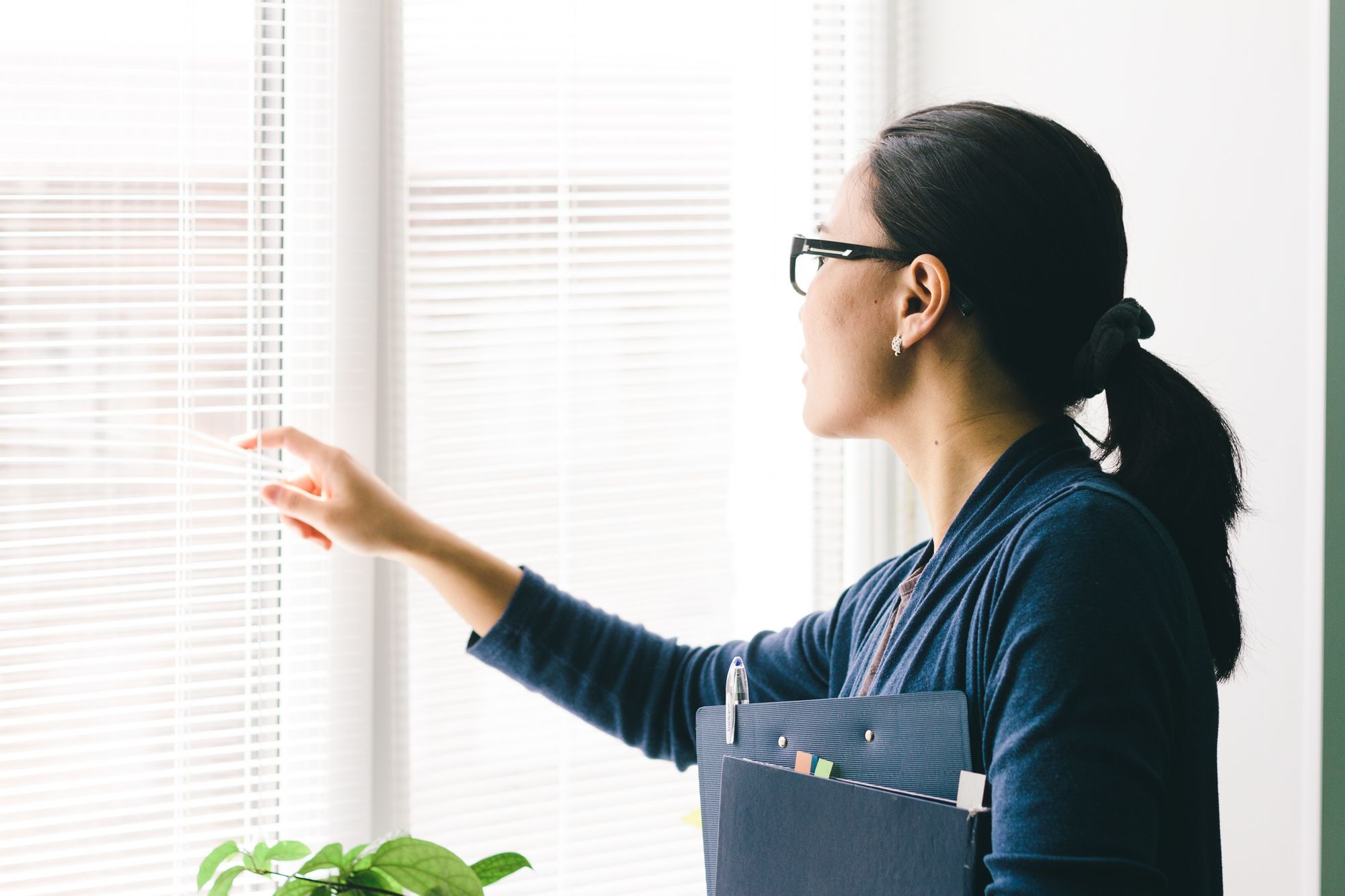 Image of a woman looking out of the window