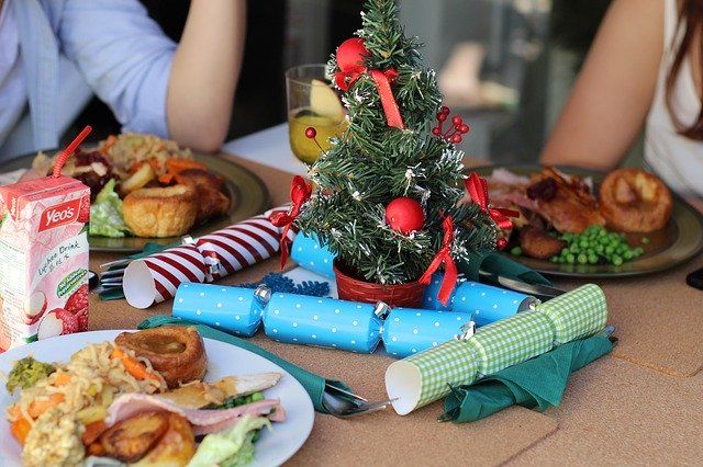 Close-up of a family dinner, a small Christmas tree in the centre of the table