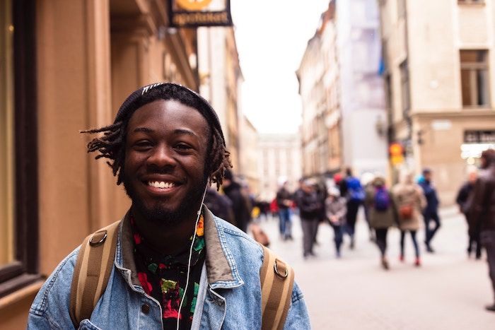 Man smiling while standing in the street