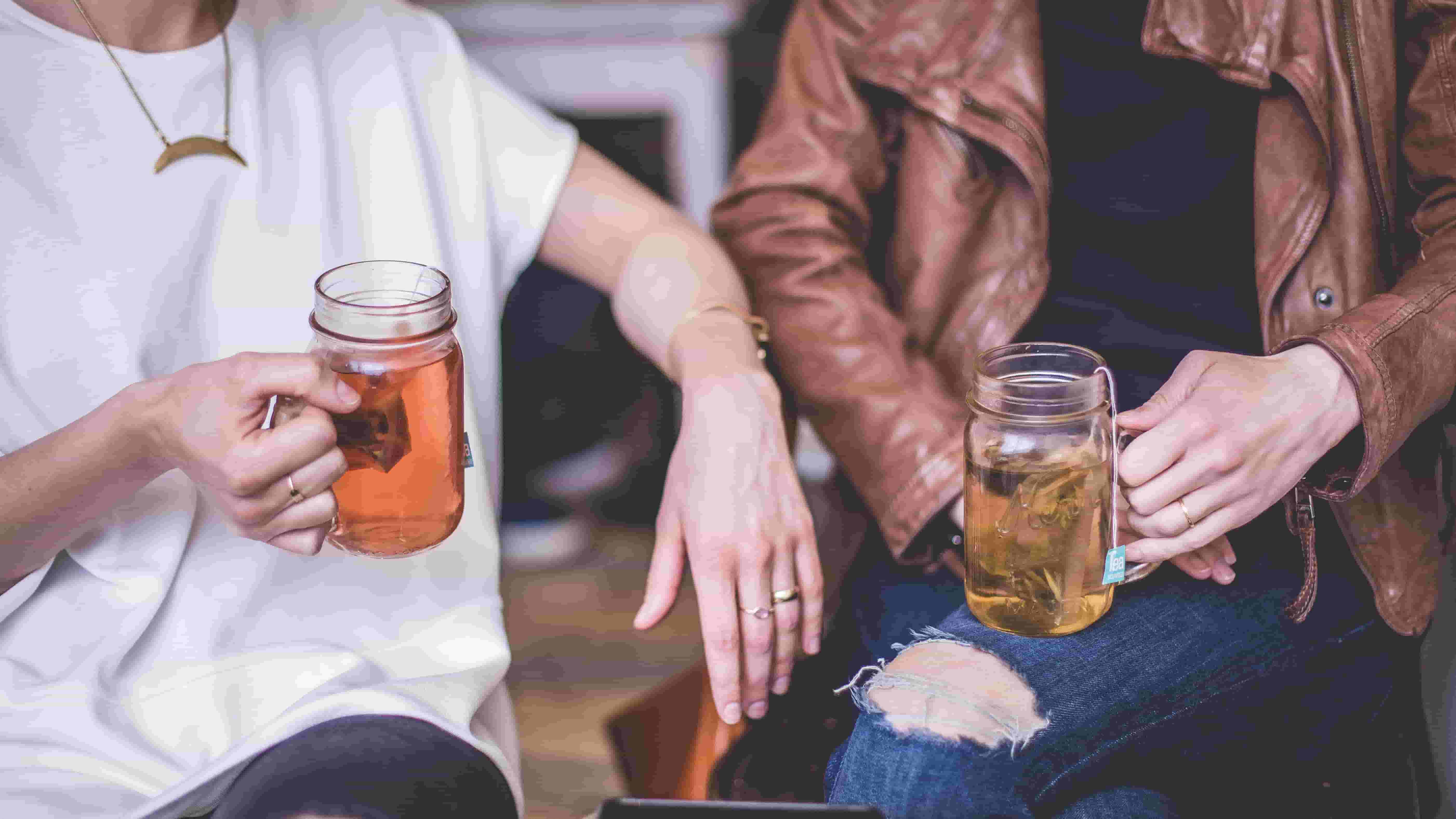 Two friends chat over tea