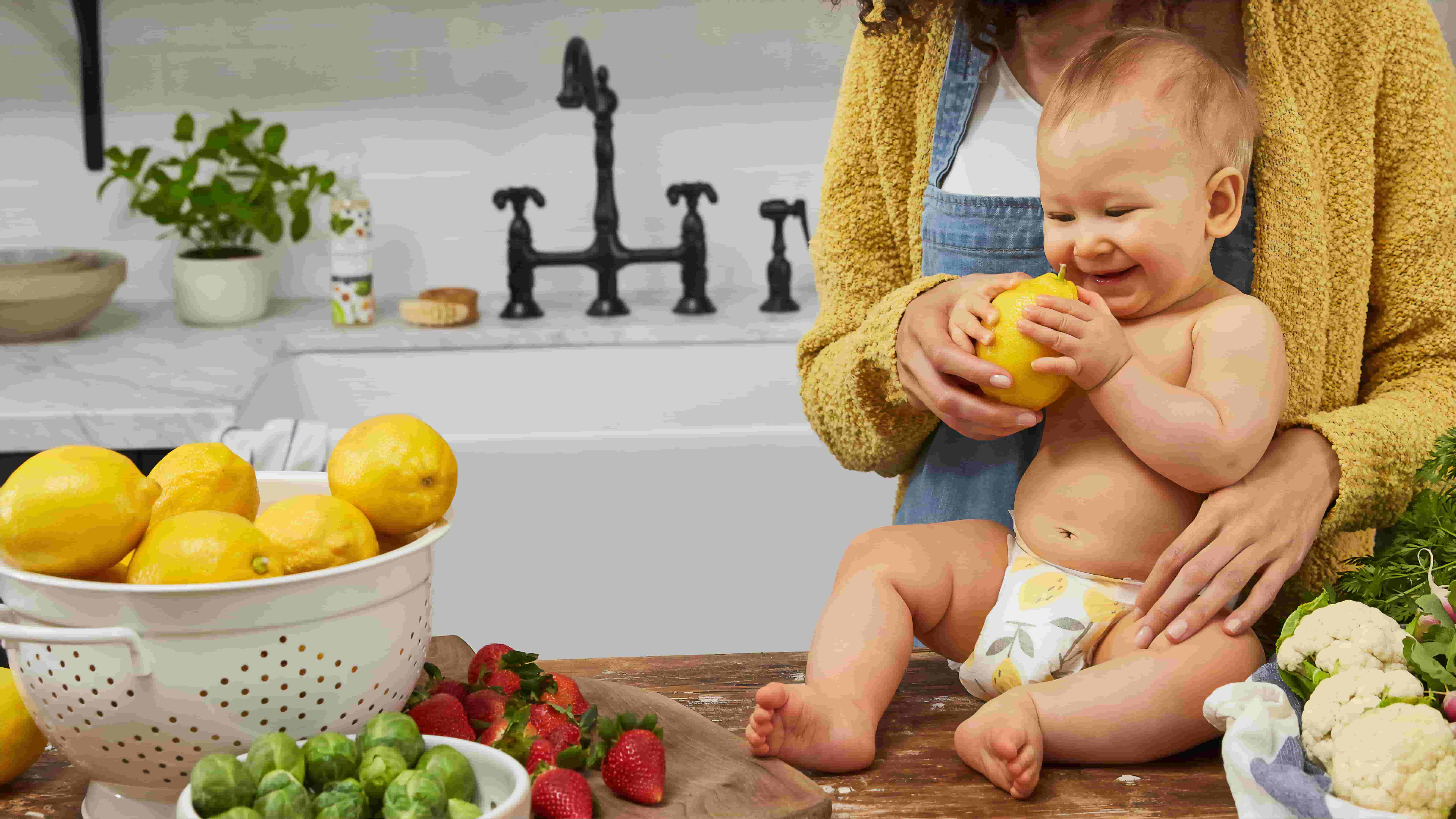 A mother teaches her young child about fruits and vegetables