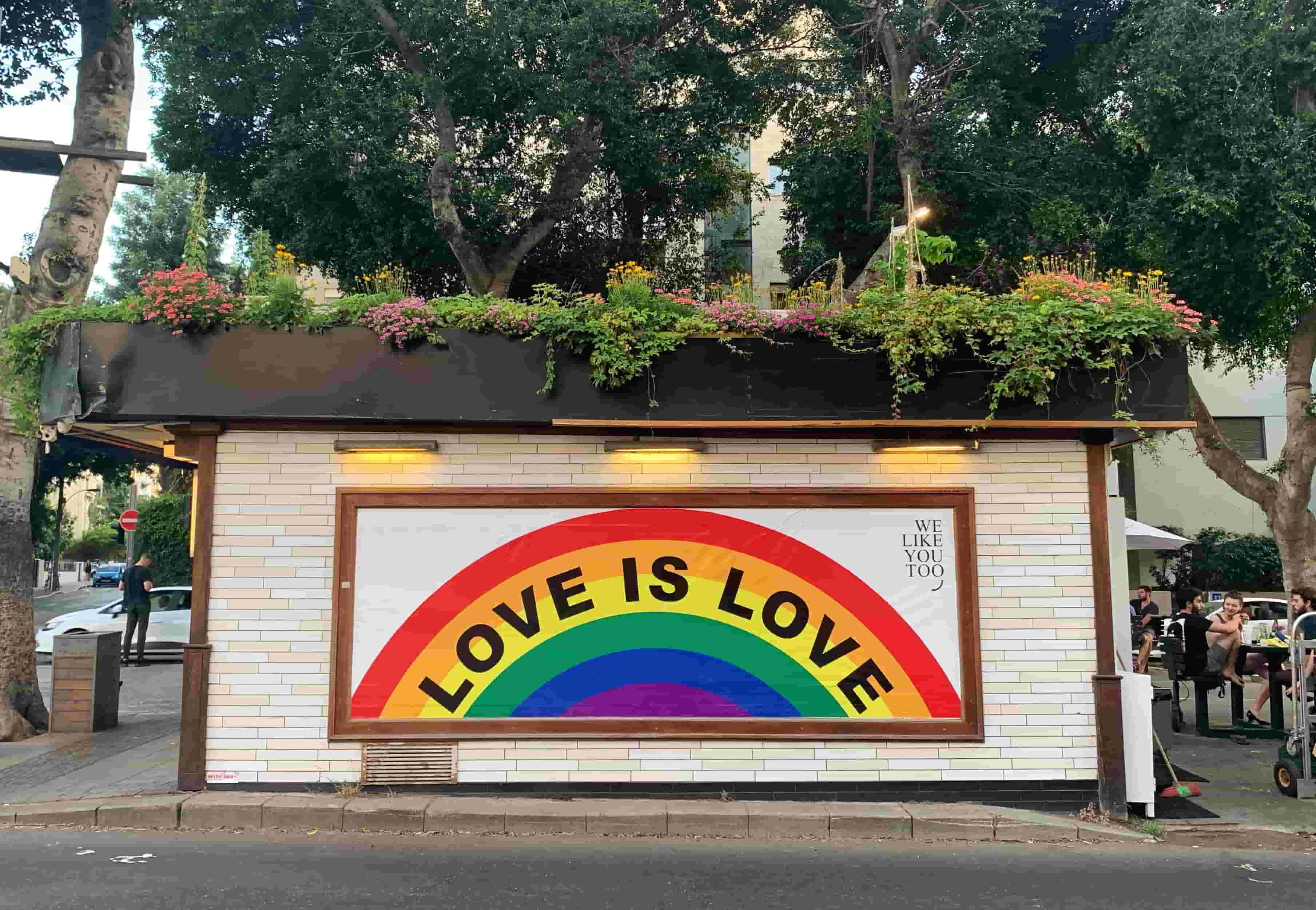 Close-up of a billboard, with 'Love is Love' written across a rainbow