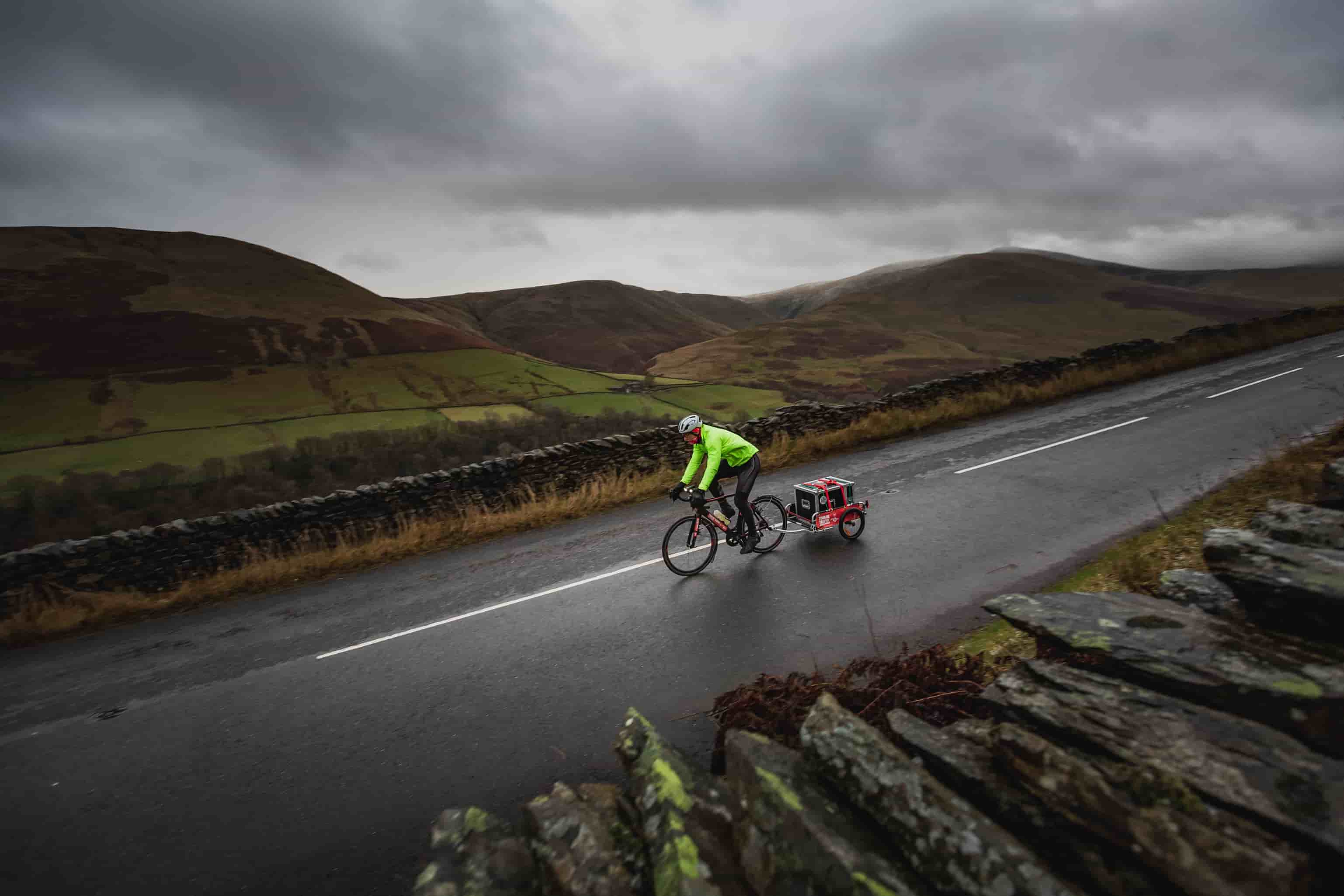 Gareth Thomas' Tour de Trophy Day 4 for sport Relief, cycling along a wet mountain road