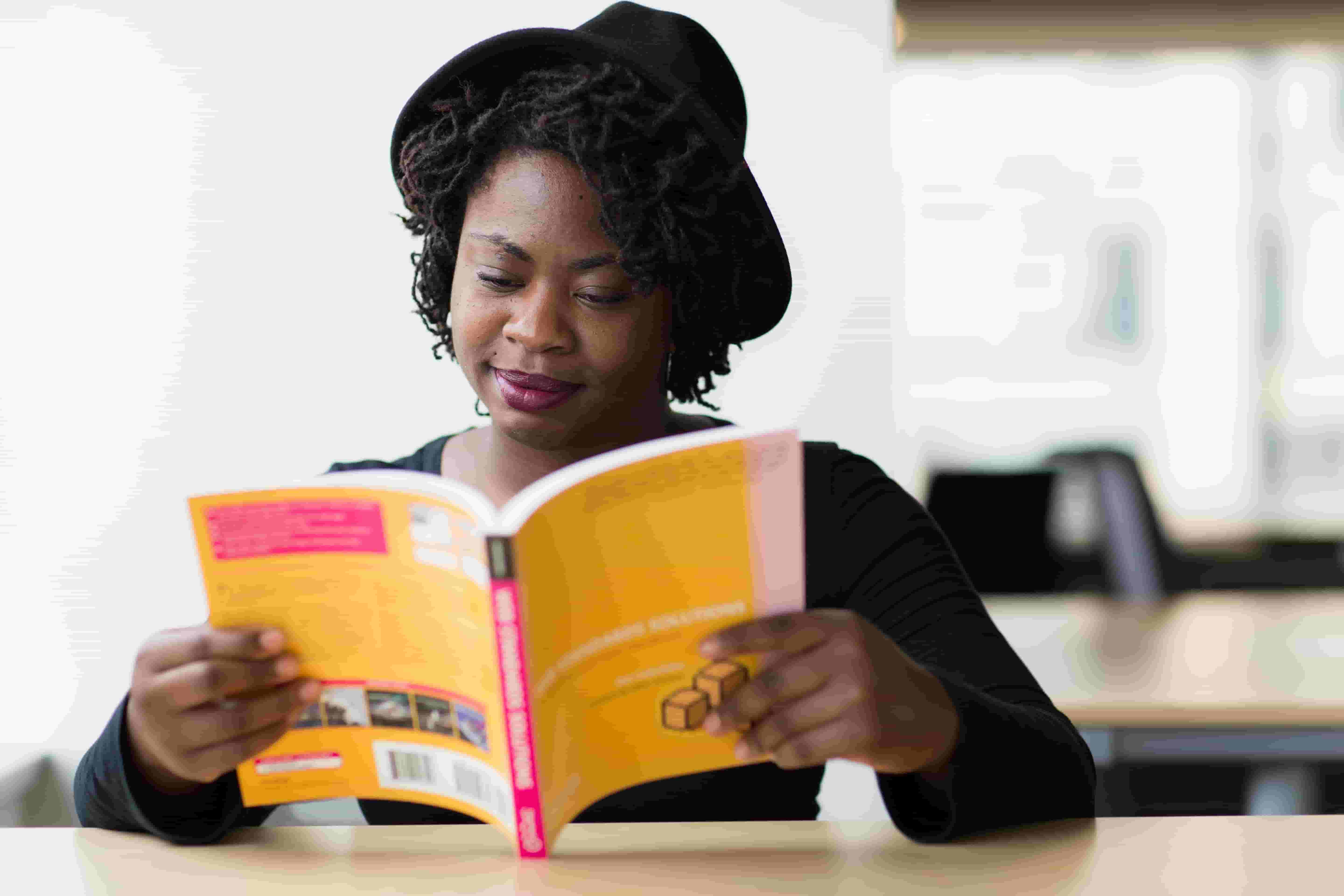 A woman reads alone in a library