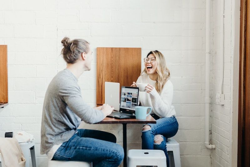 Two-People-Laughing-Over-Coffee