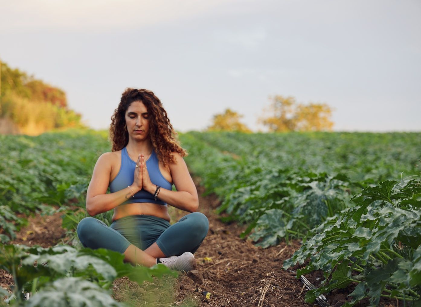 Woman meditating in green field