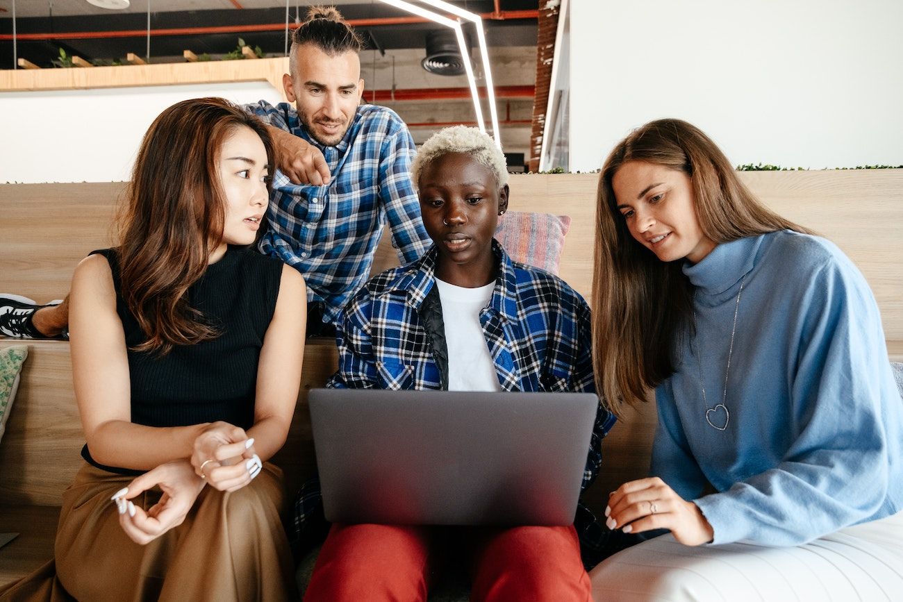 Group of people looking at laptop