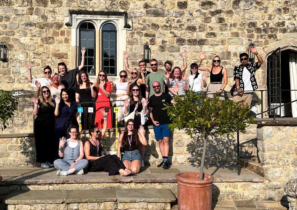 The Happiful team are waving to the camera in front of Leeds Castle